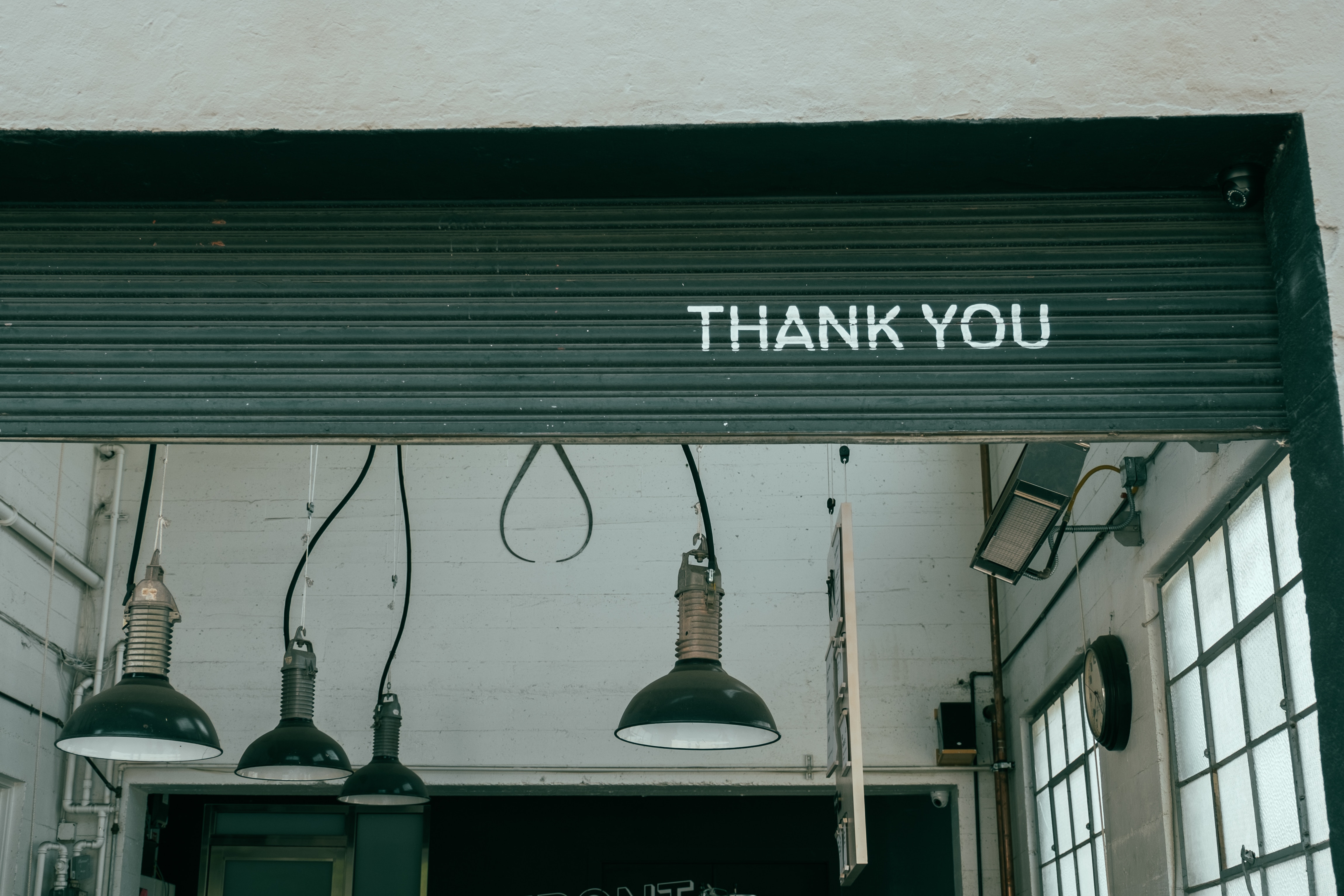 Entrance to a garage with a graffity on the door saying "THANK YOU"